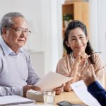 An older couple having a meeting with a business person